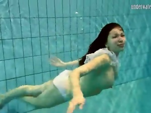 Girl in white panties swims in pool