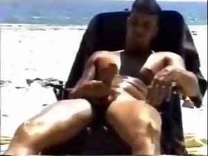 hung huge muscled straight chap jerks off on public beach.mp4